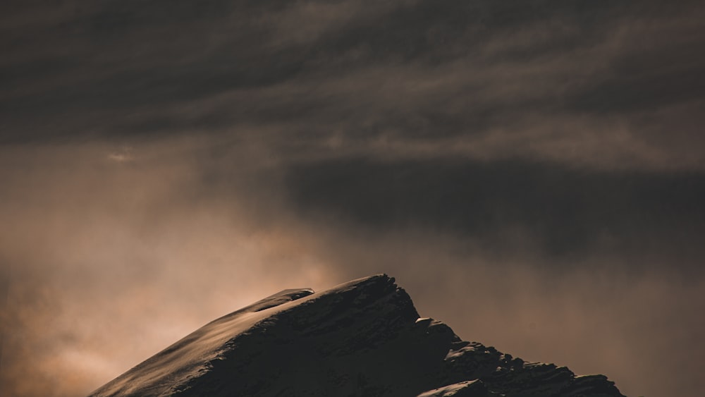 black and white mountain under gray clouds