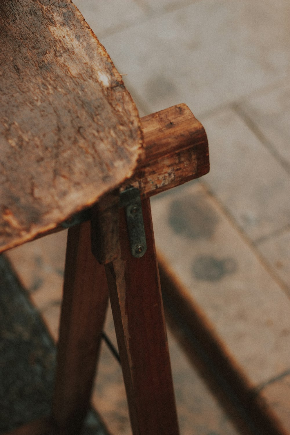 Silla de madera marrón sobre piso de concreto gris