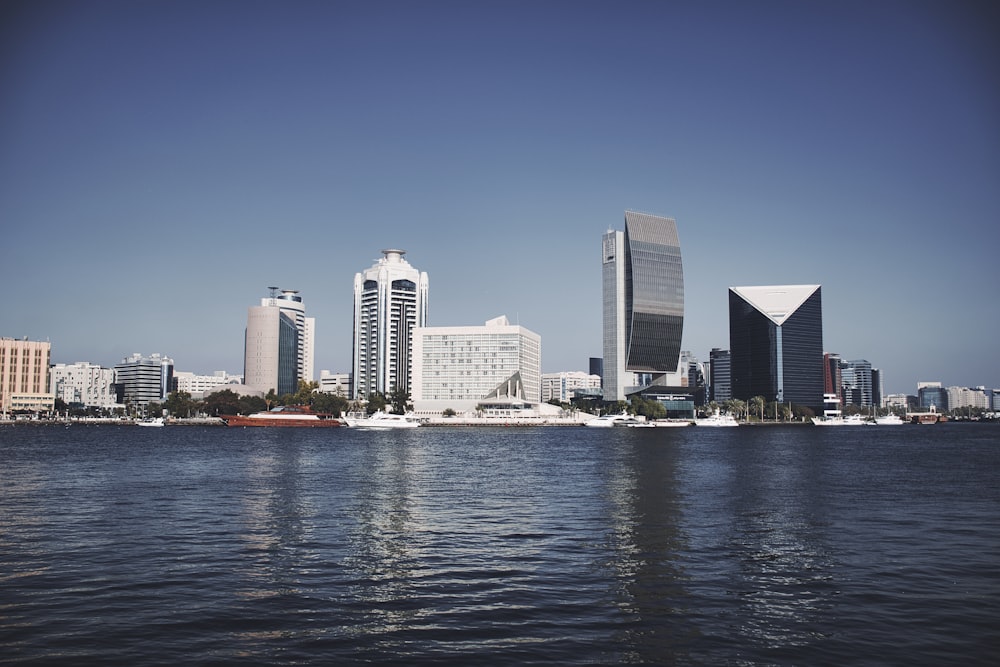 city skyline across body of water during daytime