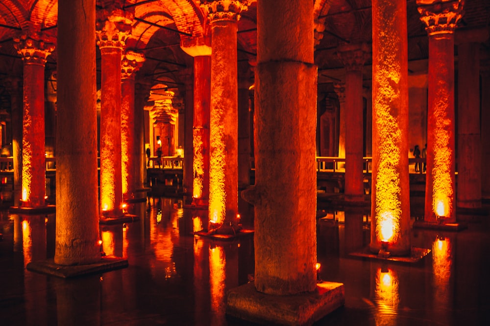 brown concrete pillar near body of water during night time