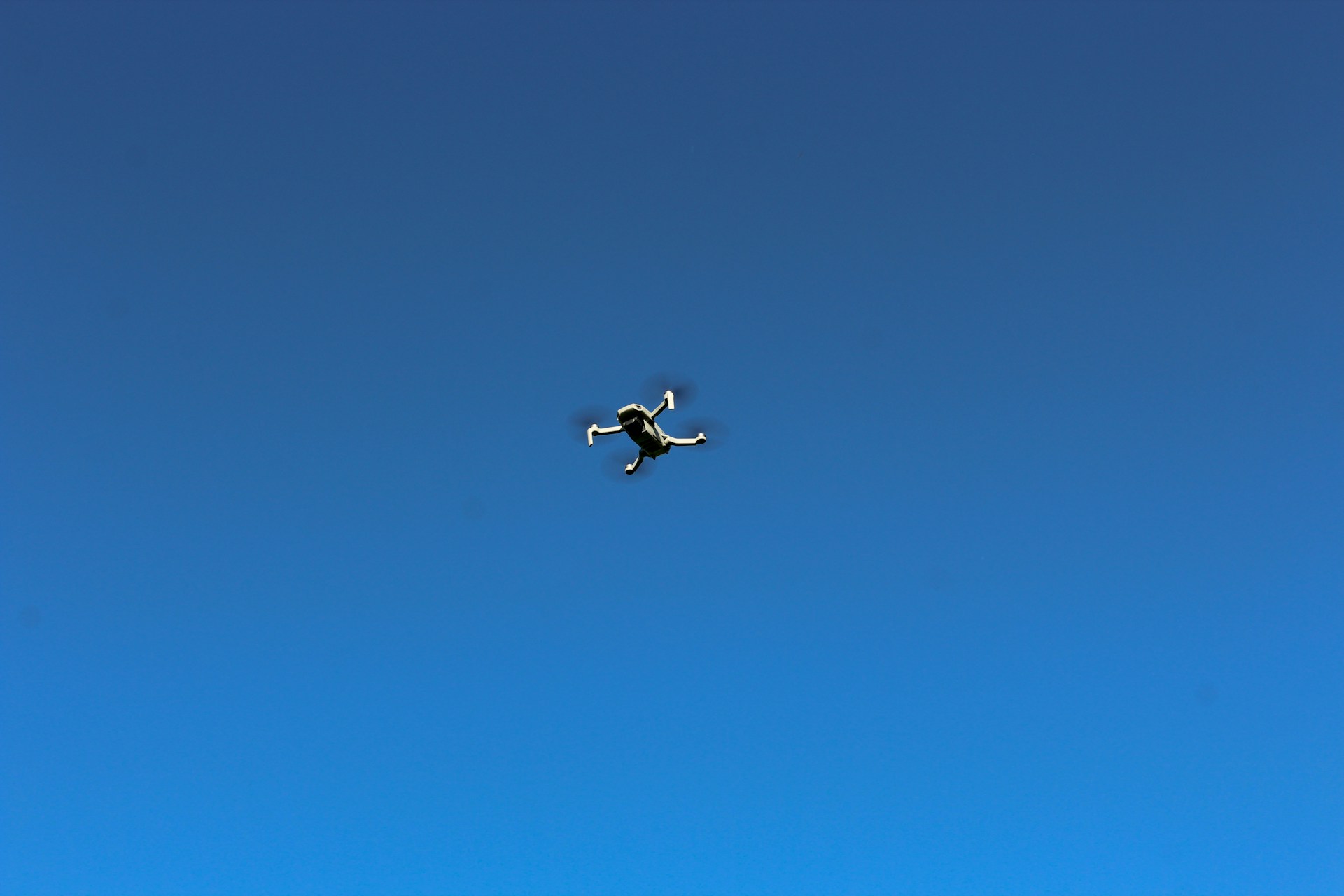 woman wearing yellow long-sleeved dress under white clouds and blue sky during daytime