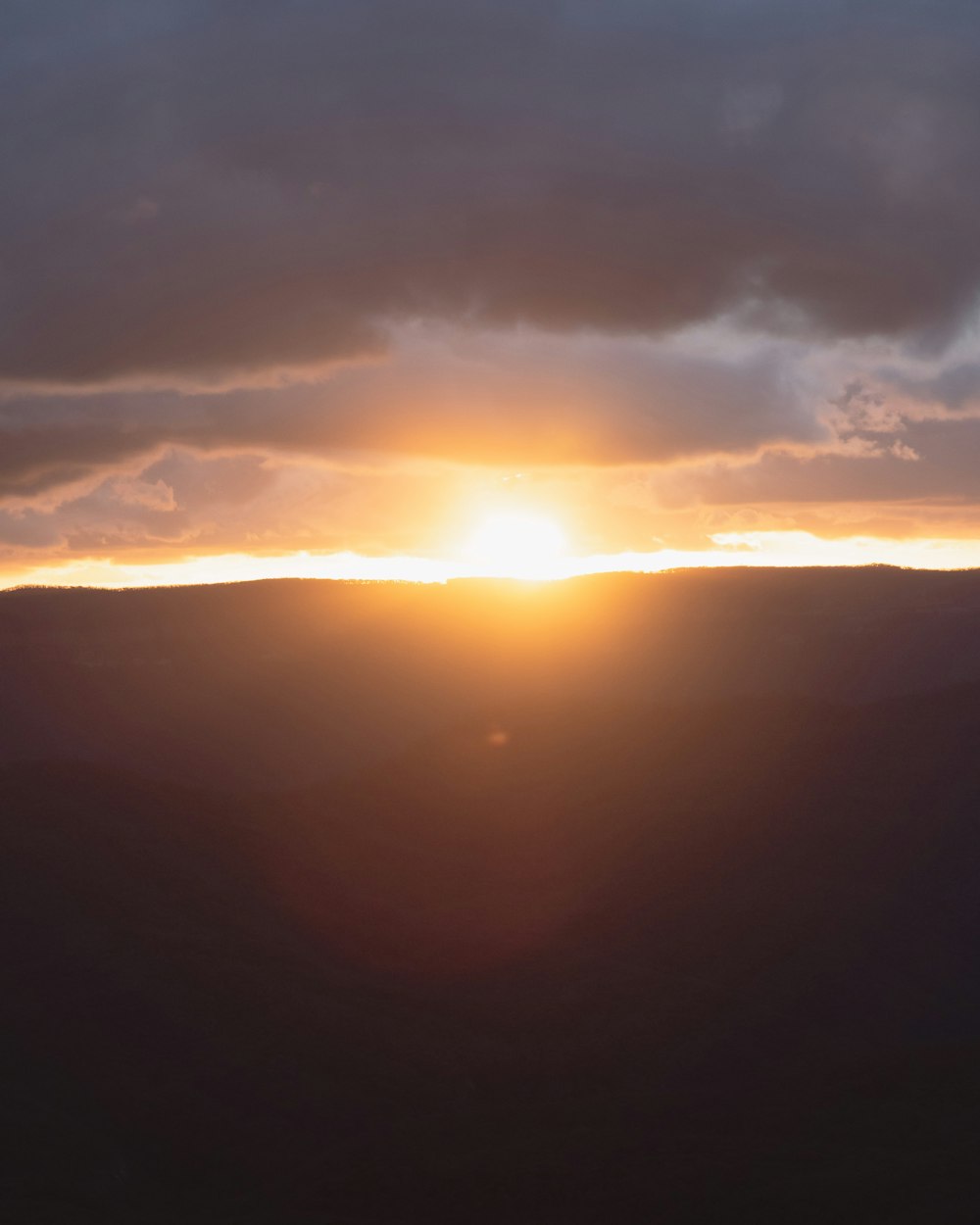 sun setting over the clouds