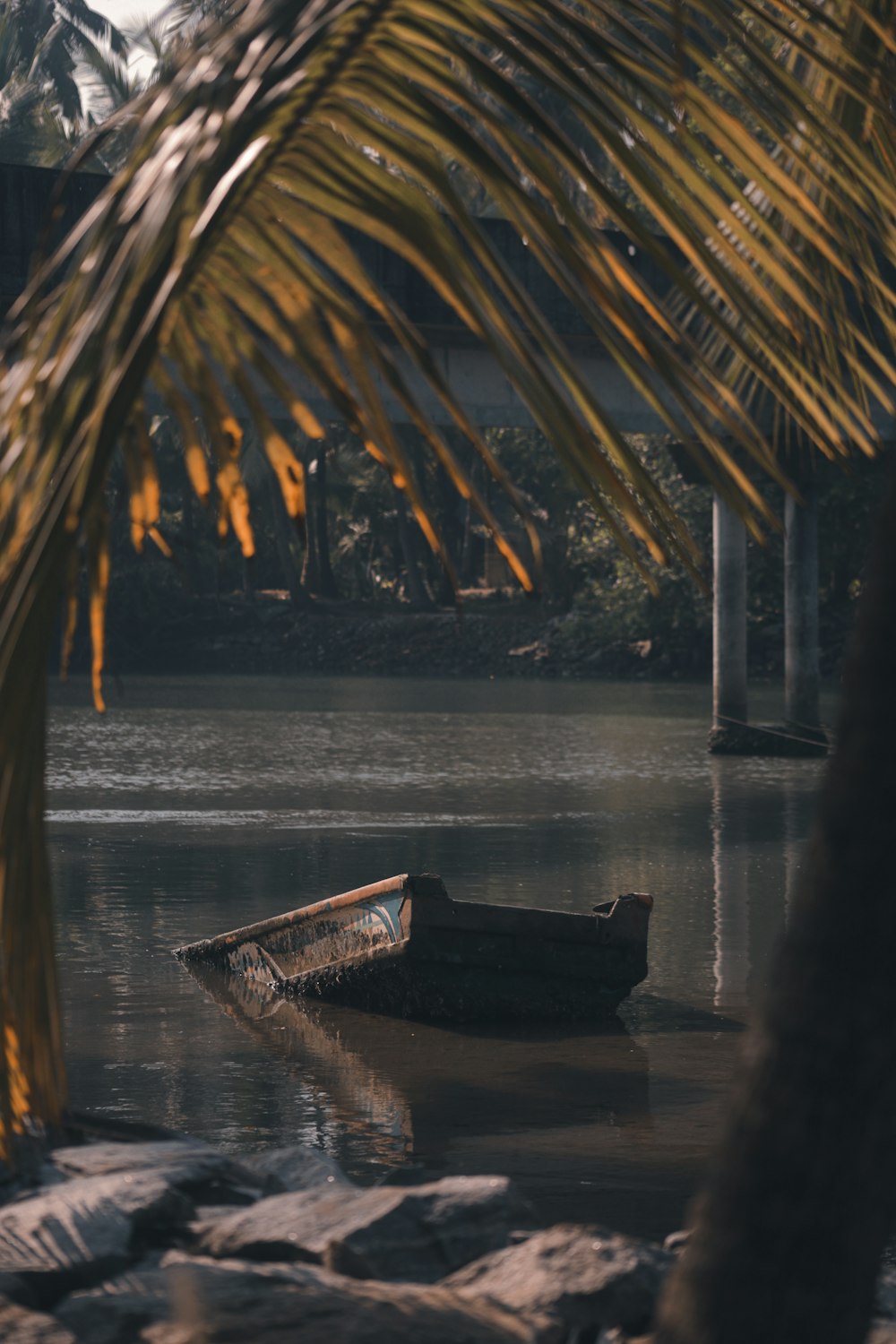 brown wooden boat on water during sunset