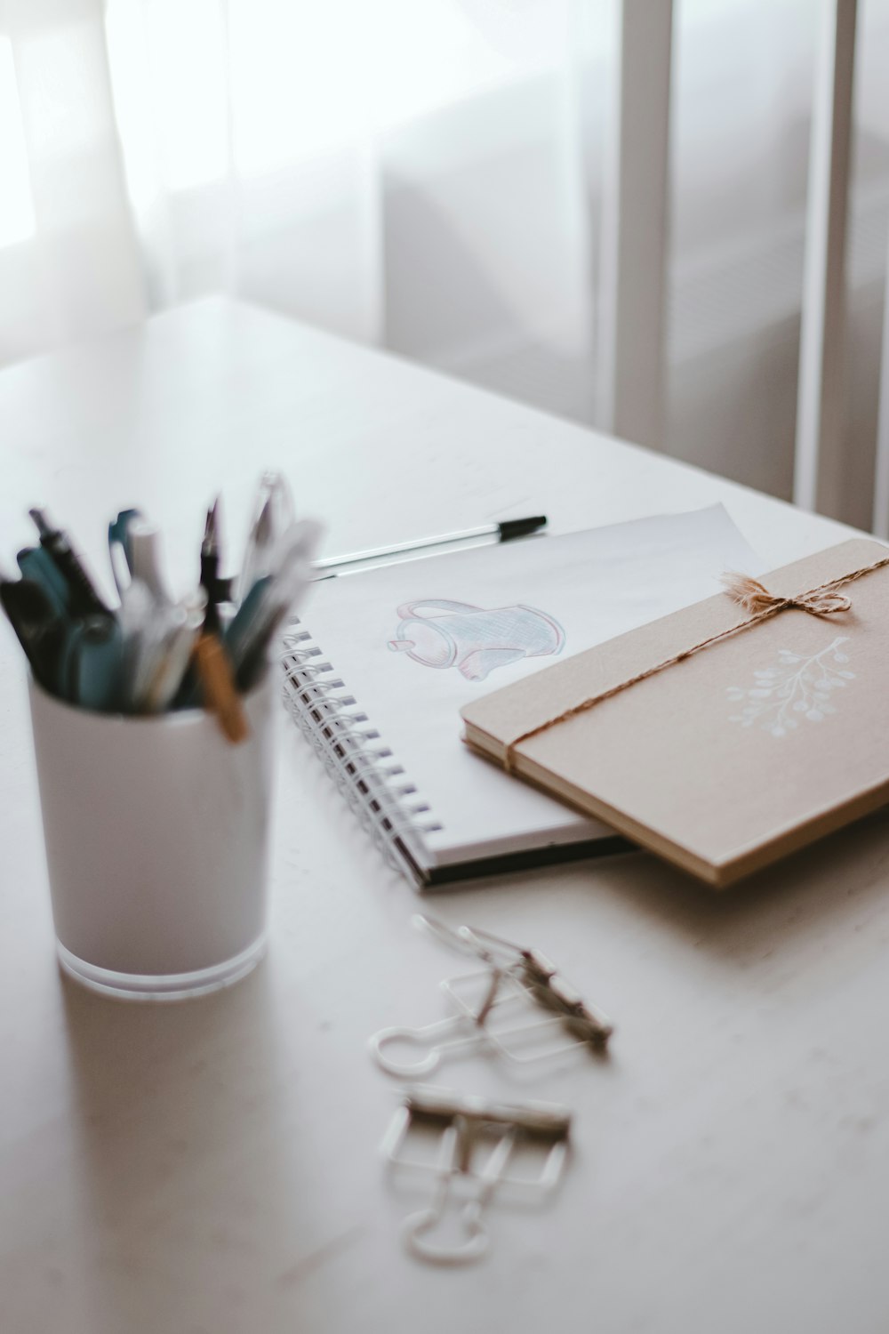 pens and scissors on white ceramic mug