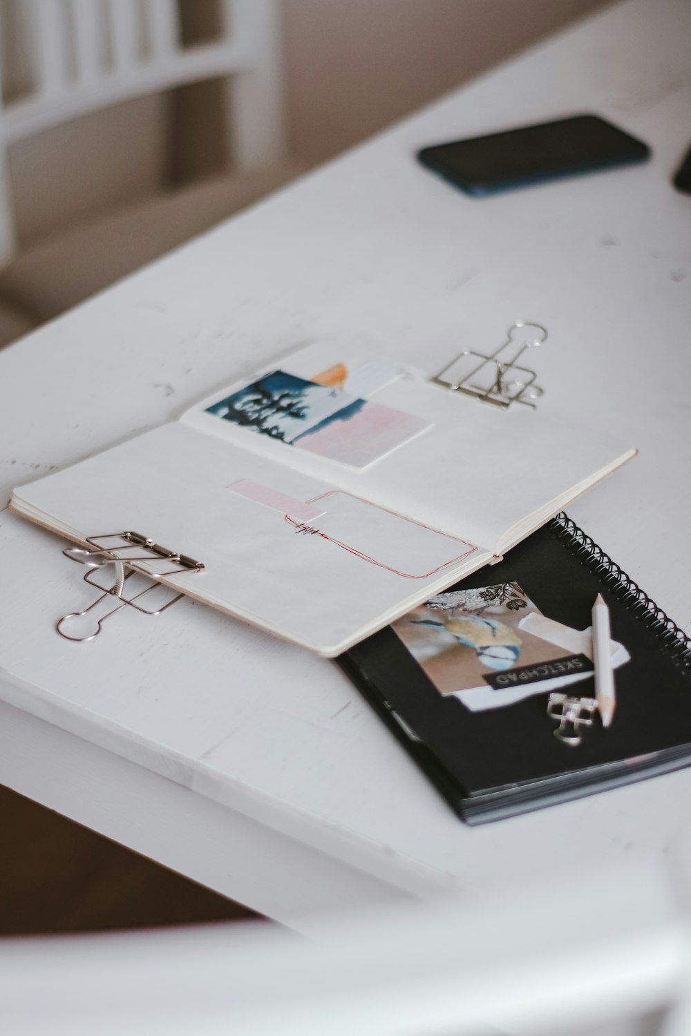 white spiral notebook on white table