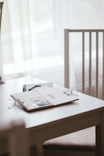 A calm, inviting workspace with a meditation cushion, soft natural light, and a notebook open to a simple meditation plan.