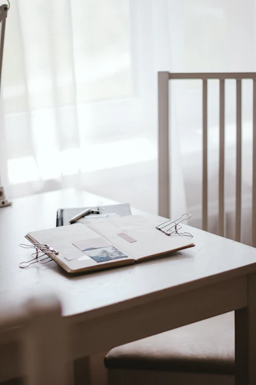 A warm, inviting workspace with soft violet and white tones, featuring a notebook and a pen ready for ideas.
