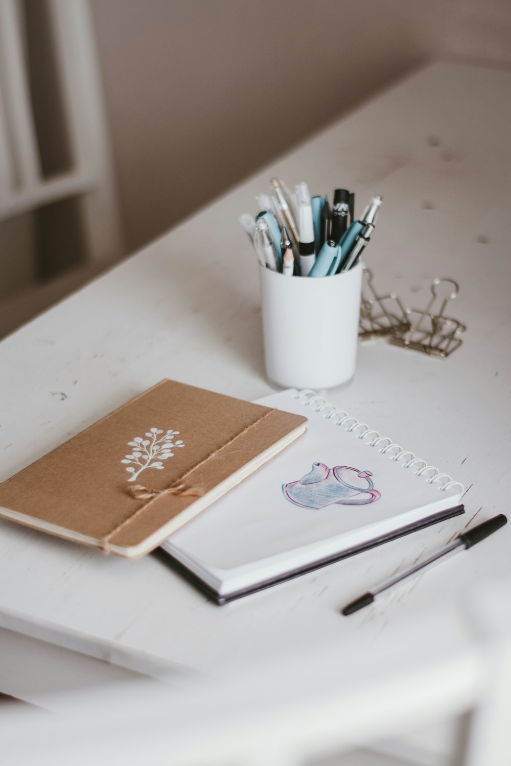 white and orange floral book on white table