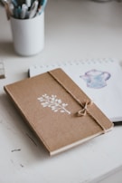 brown and white floral book