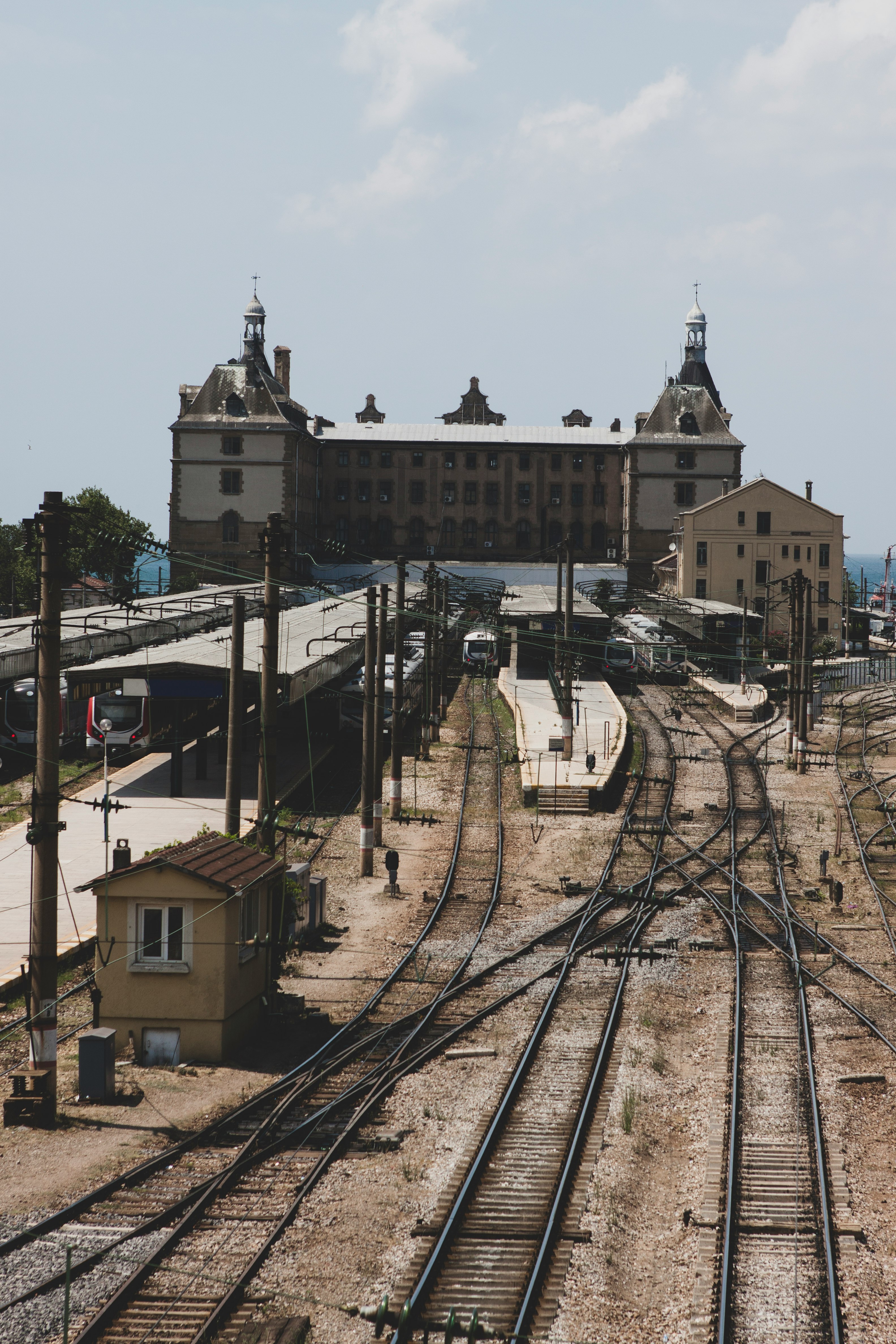 train rail near concrete building during daytime