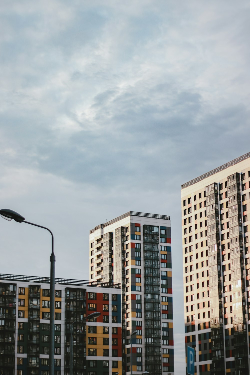 white and brown concrete building under white clouds during daytime