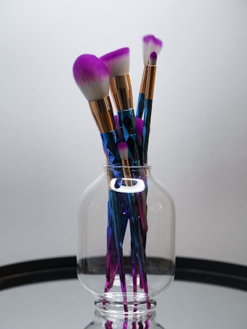makeup brushes in clear glass container