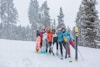 people in blue and red jacket and pants standing on snow covered ground during daytime