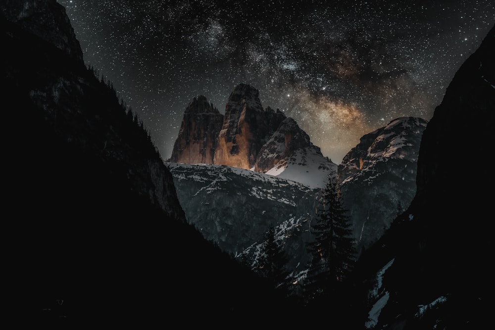 brown rocky mountain under starry night