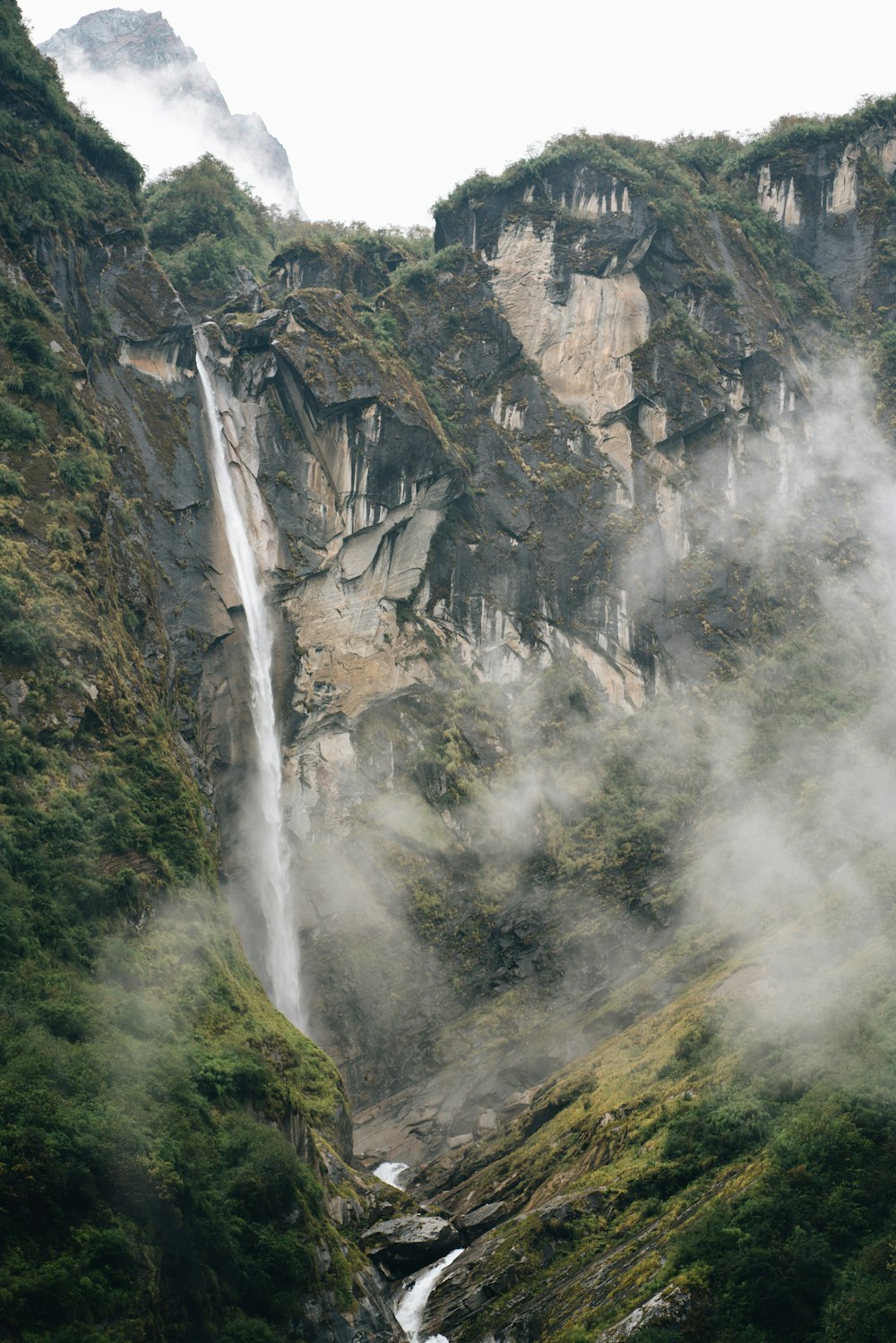 waterfalls on rocky mountain during daytime