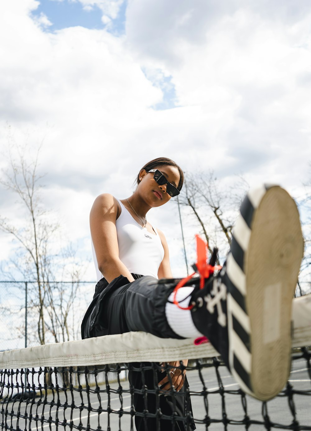 woman in black tank top and black shorts wearing black sunglasses