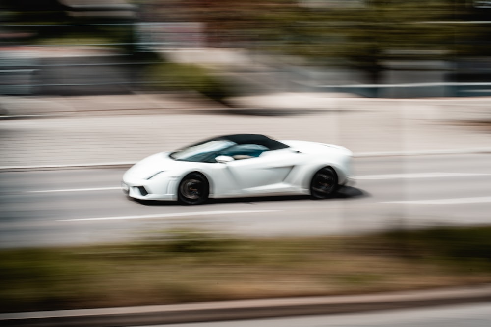 white coupe on road during daytime