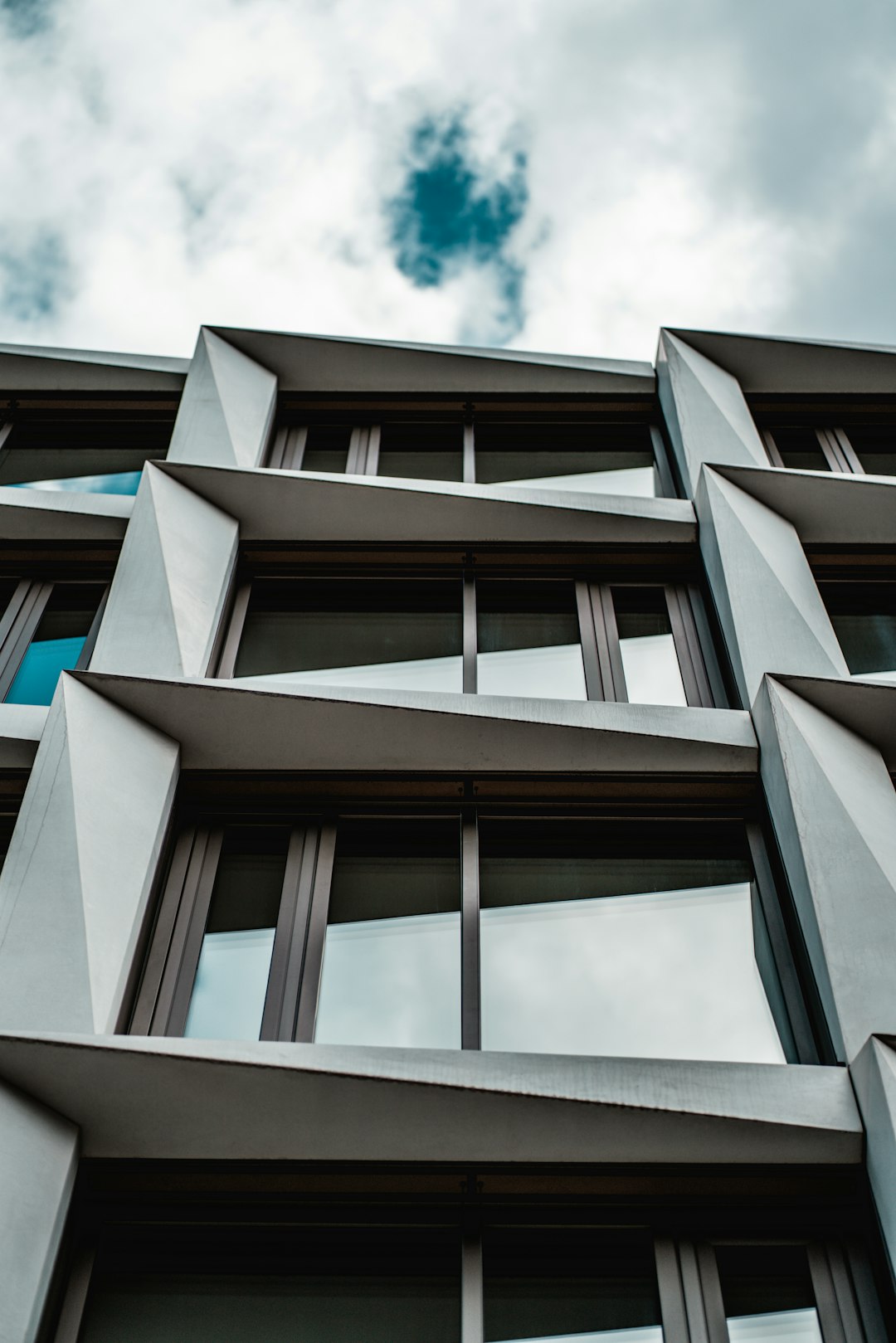 brown concrete building under white clouds during daytime