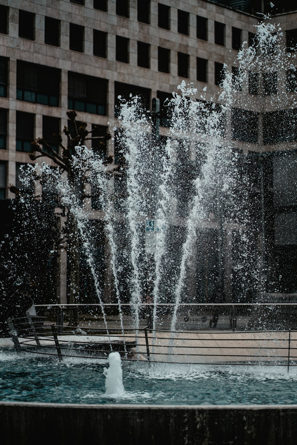 water fountain in front of brown building