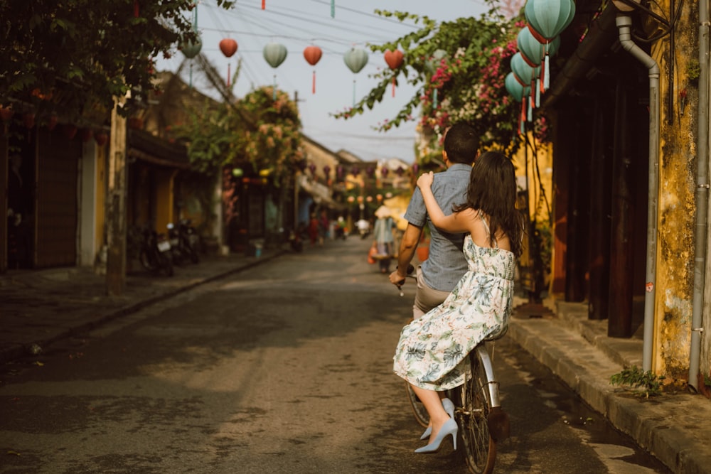 woman in white and green floral dress walking on street during daytime