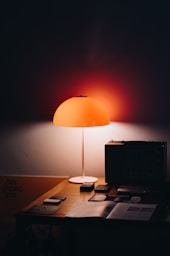 black laptop computer on brown wooden table