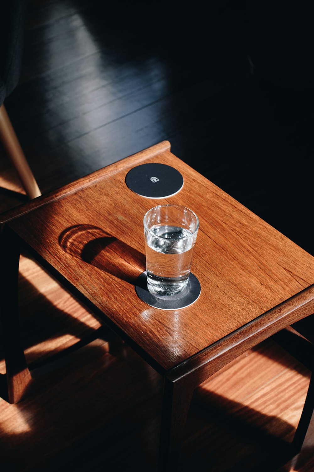 clear drinking glass on brown wooden table