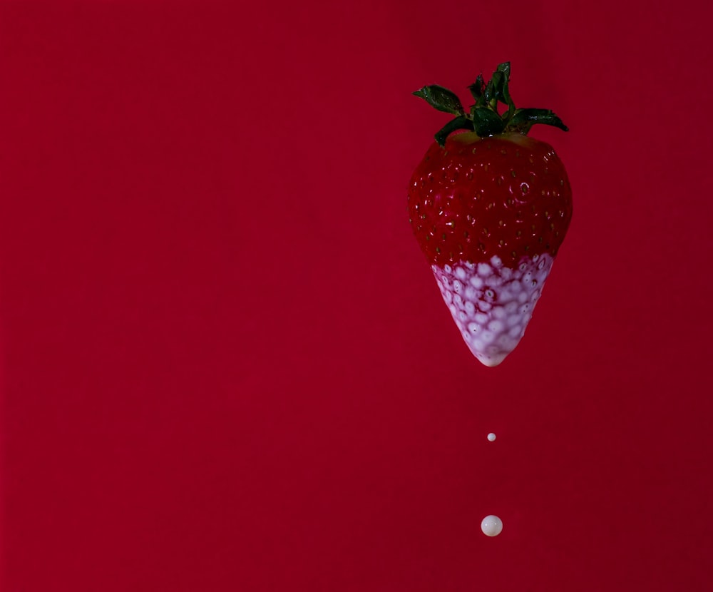 strawberry fruit on red surface