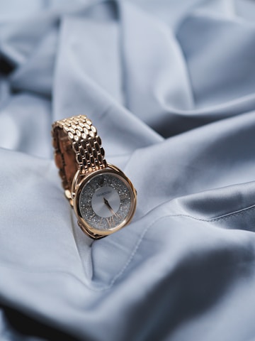 gold and silver round analog watch