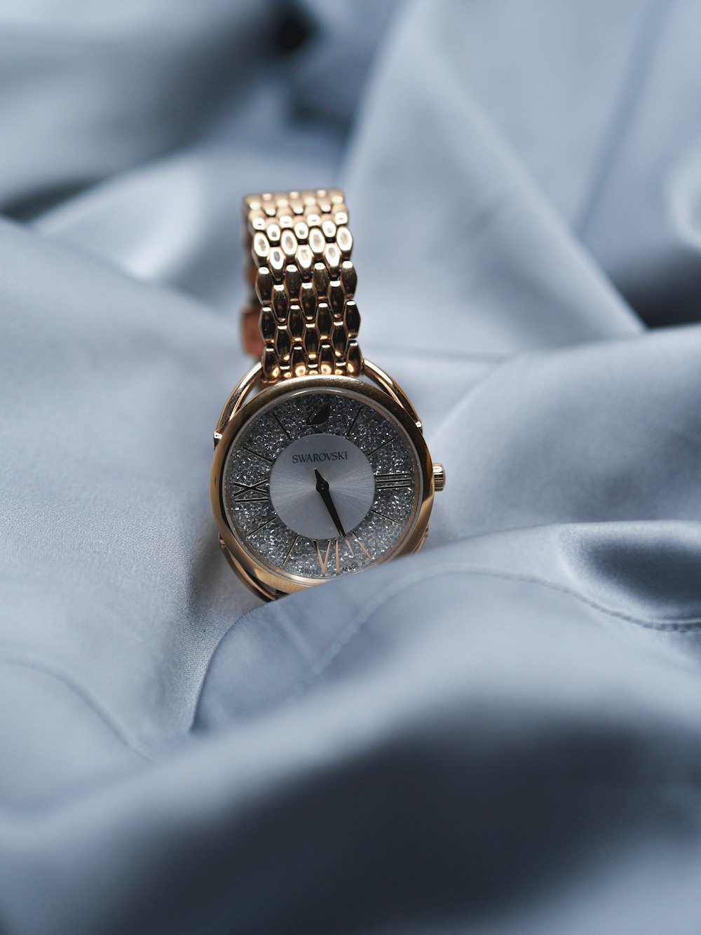 gold and silver round analog watch