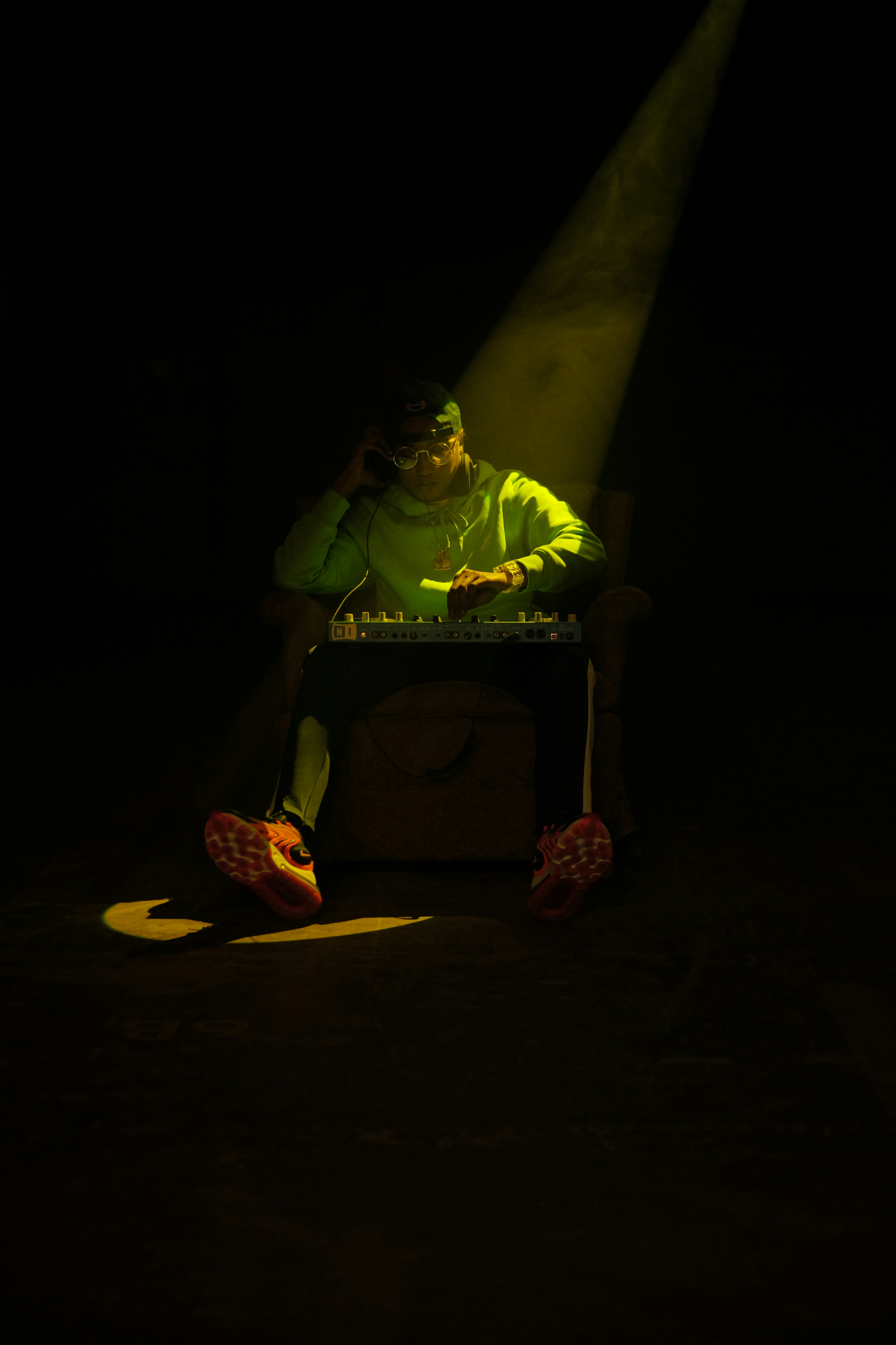 man in green shirt sitting on brown wooden chair