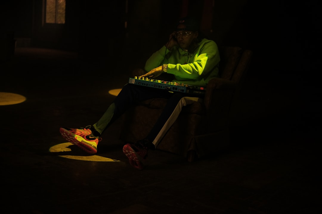 man in green shirt playing piano