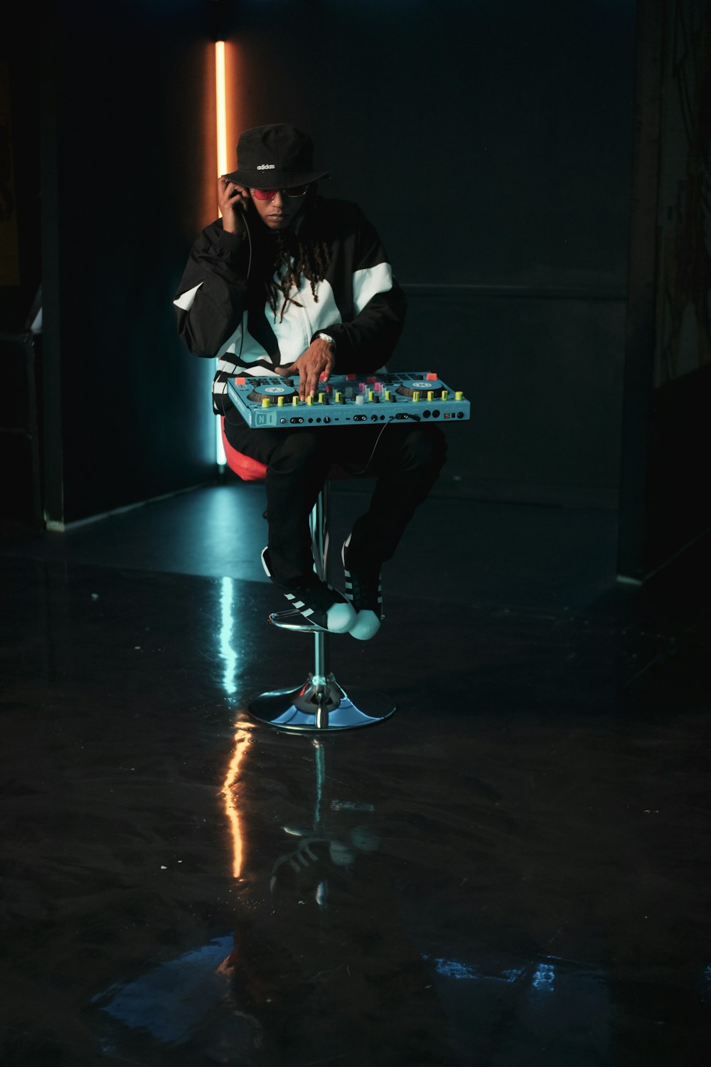 man in black and white jacket playing electric guitar