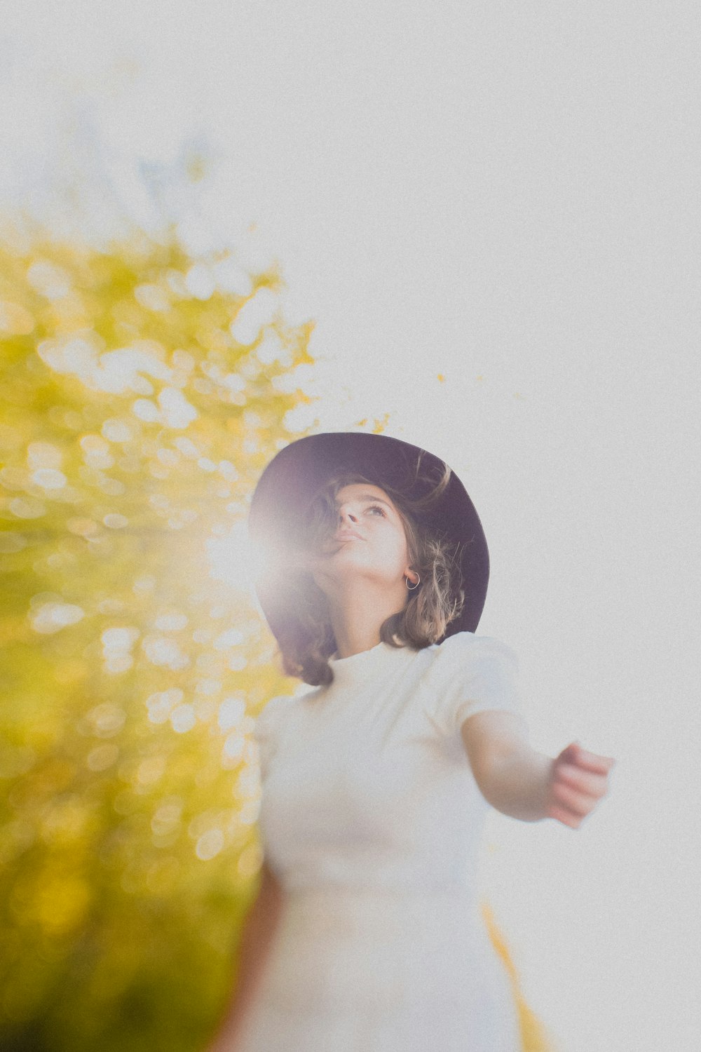 girl in white shirt standing and smiling