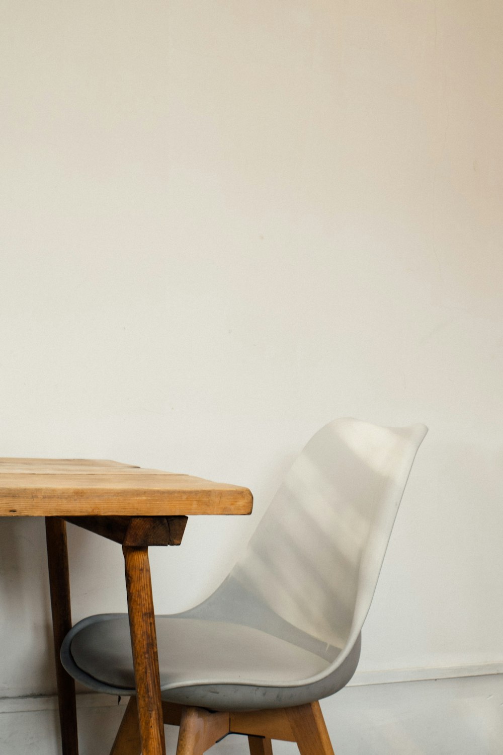 white plastic chair beside brown wooden table