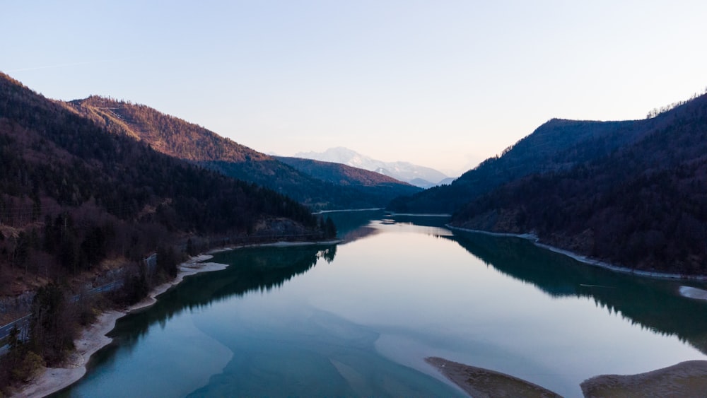 lake in the middle of mountains during daytime