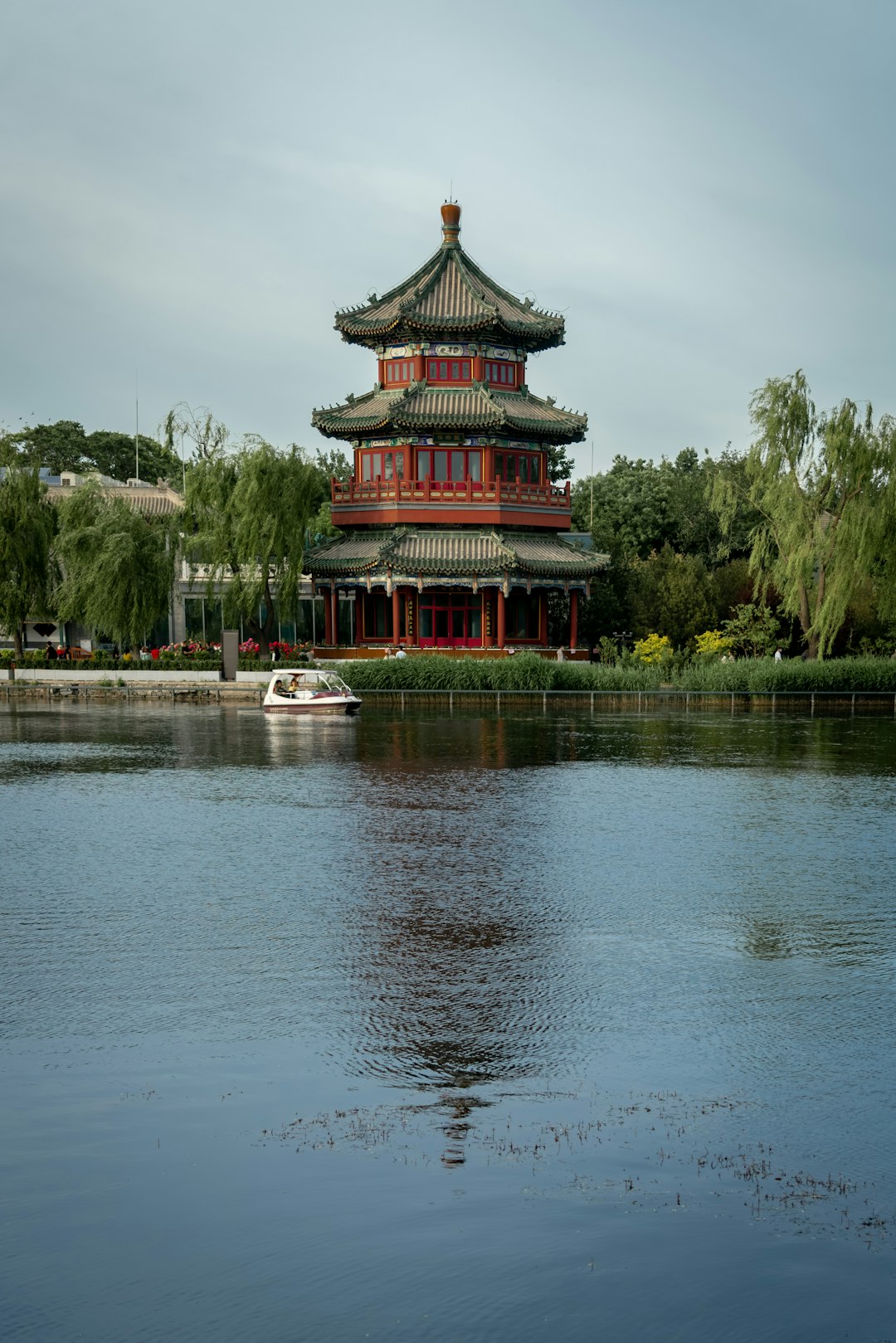 red and black temple near body of water during daytime