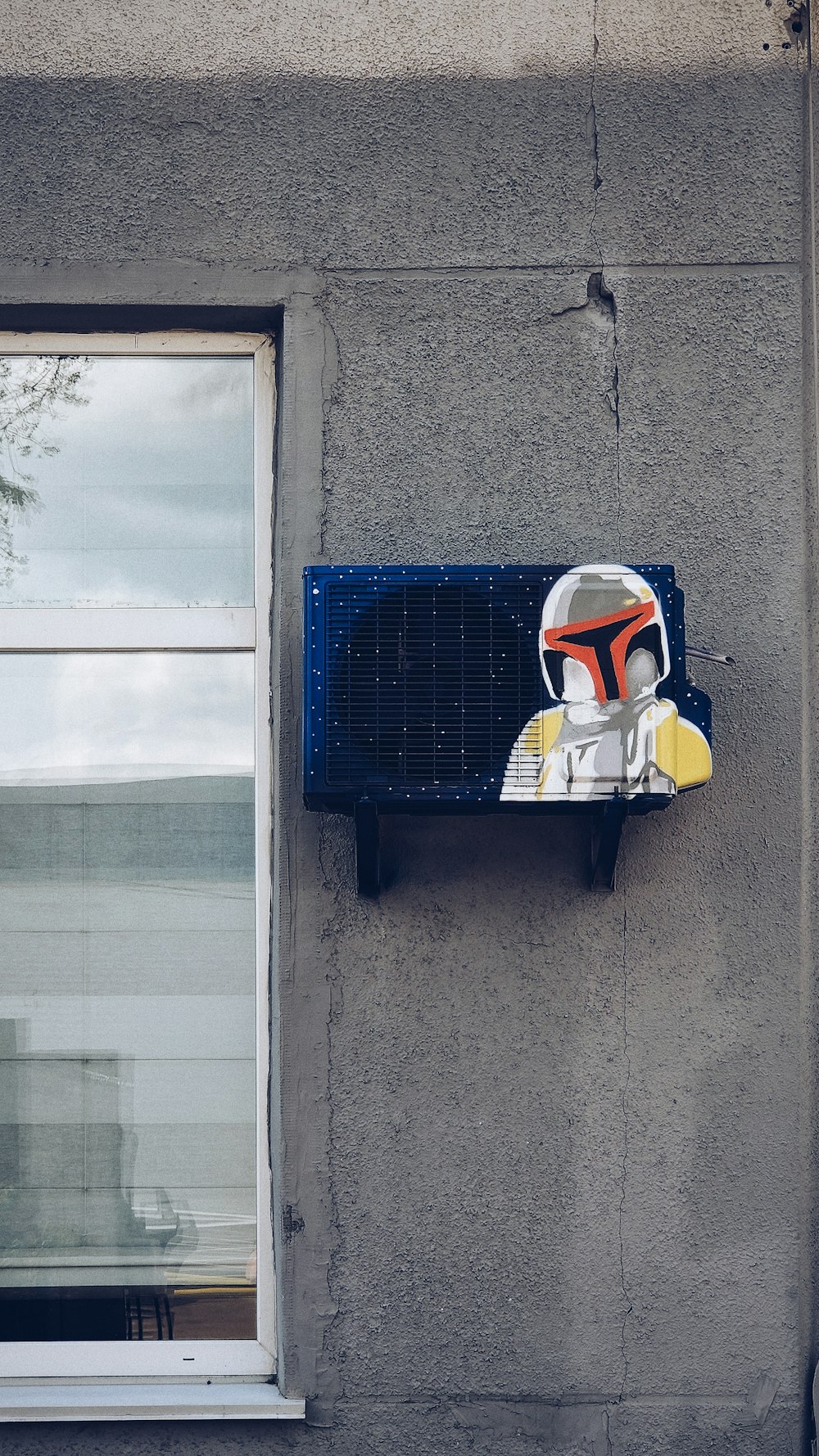 blue and white box on gray concrete wall