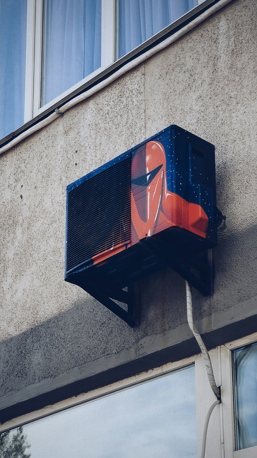 blue and red plastic trash bin