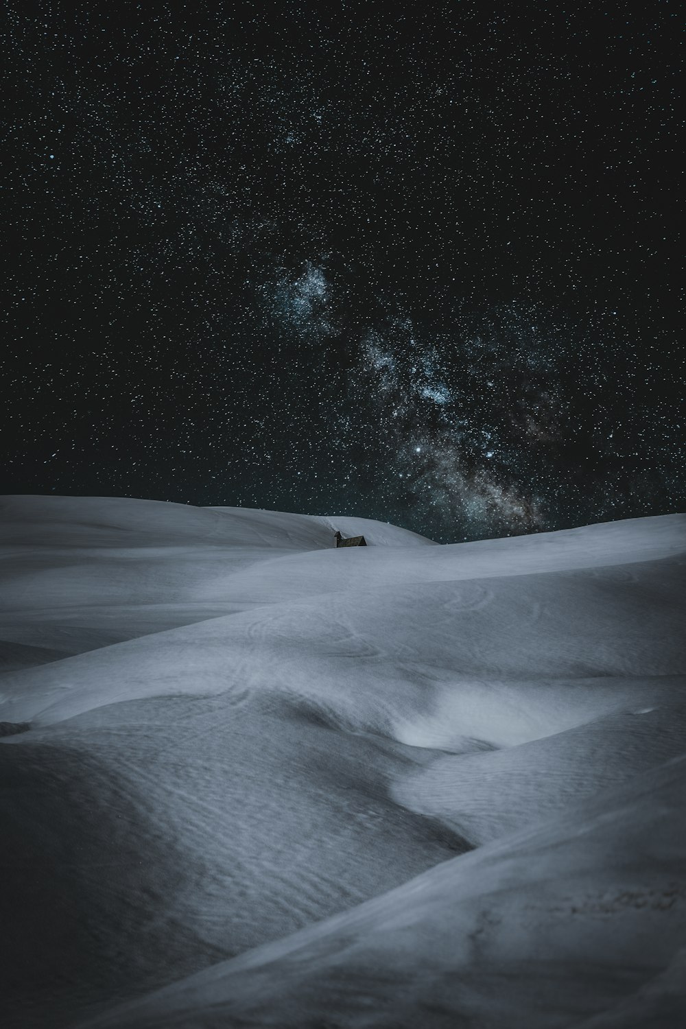 snow covered field during night time