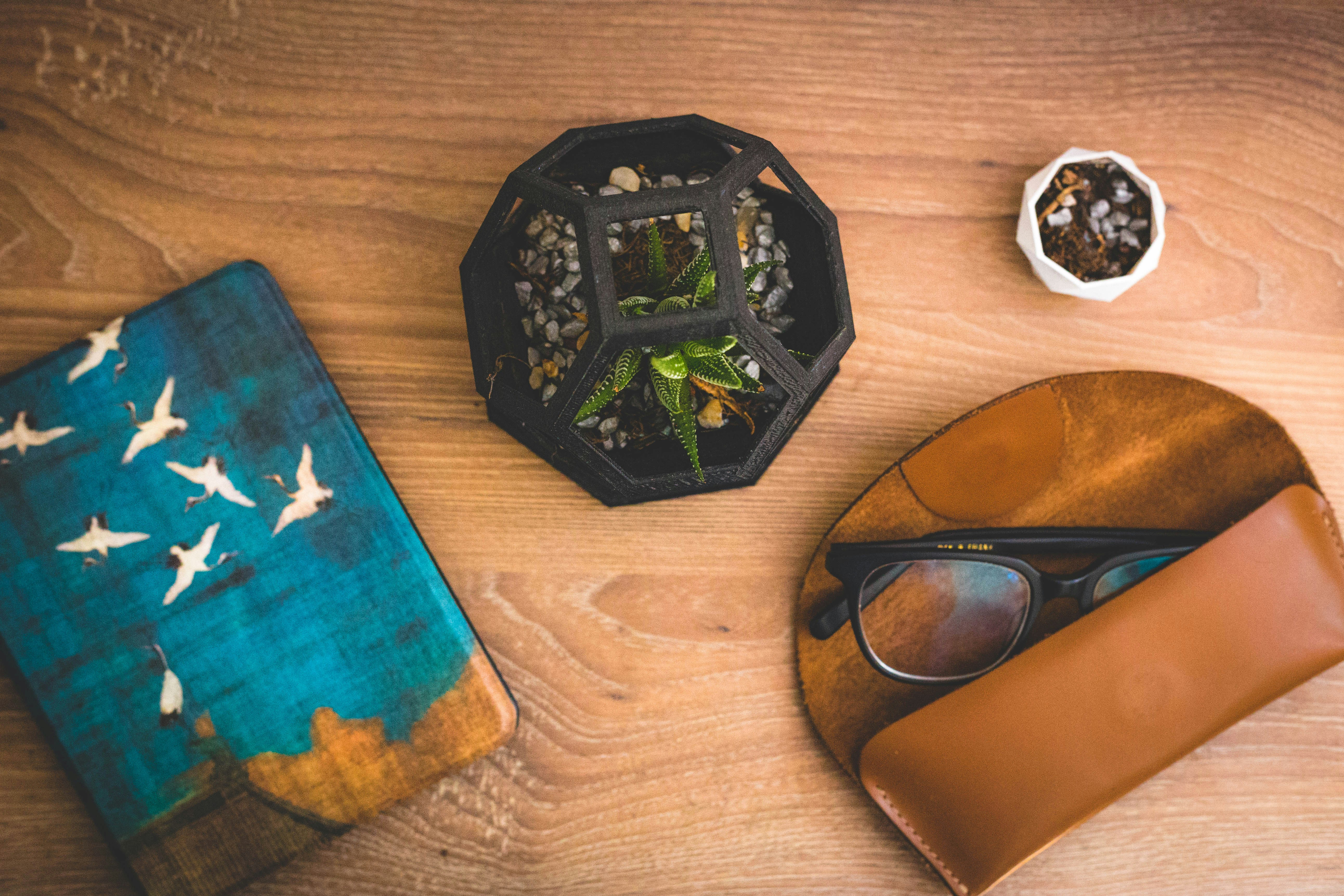 black round glass ashtray beside brown leather bifold wallet
