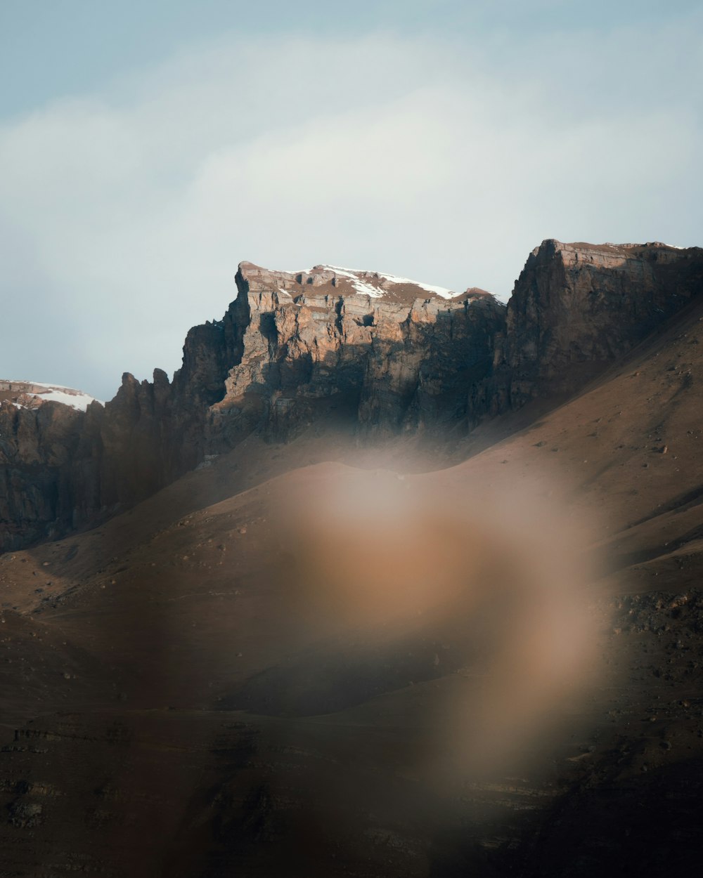 brown rocky mountain under white sky during daytime