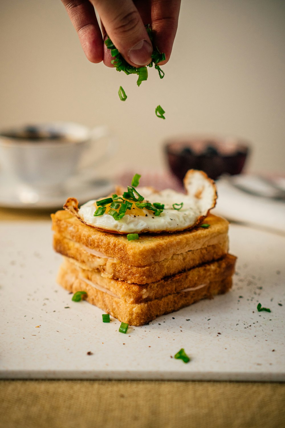 sliced bread with green vegetable on white ceramic plate