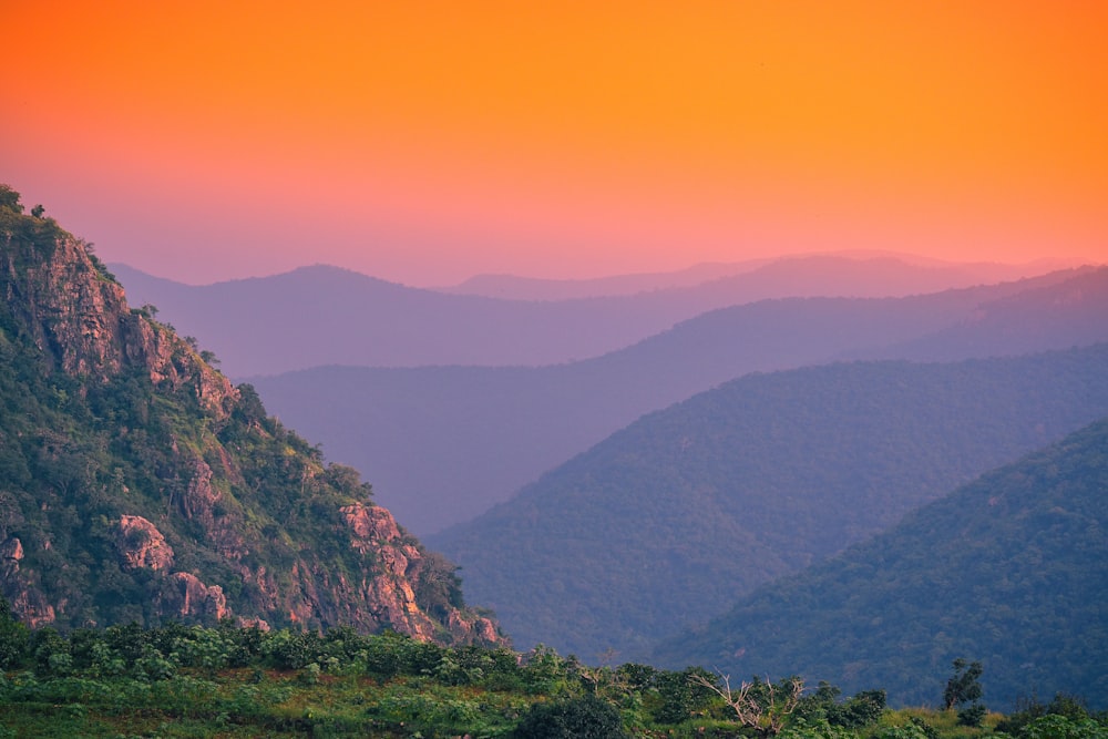 green grass covered mountain during daytime