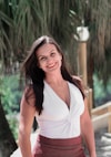 woman in white halter top smiling