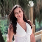 woman in white halter top smiling