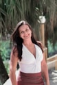 woman in white halter top smiling