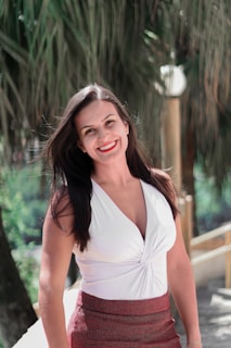 woman in white halter top smiling