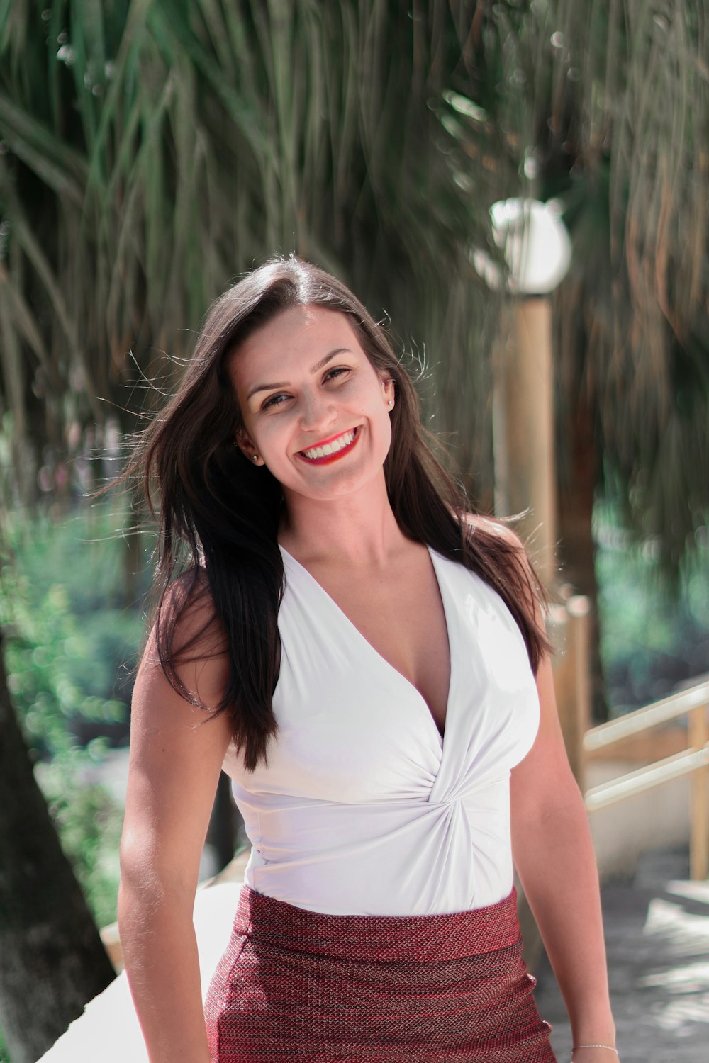 woman in white halter top smiling