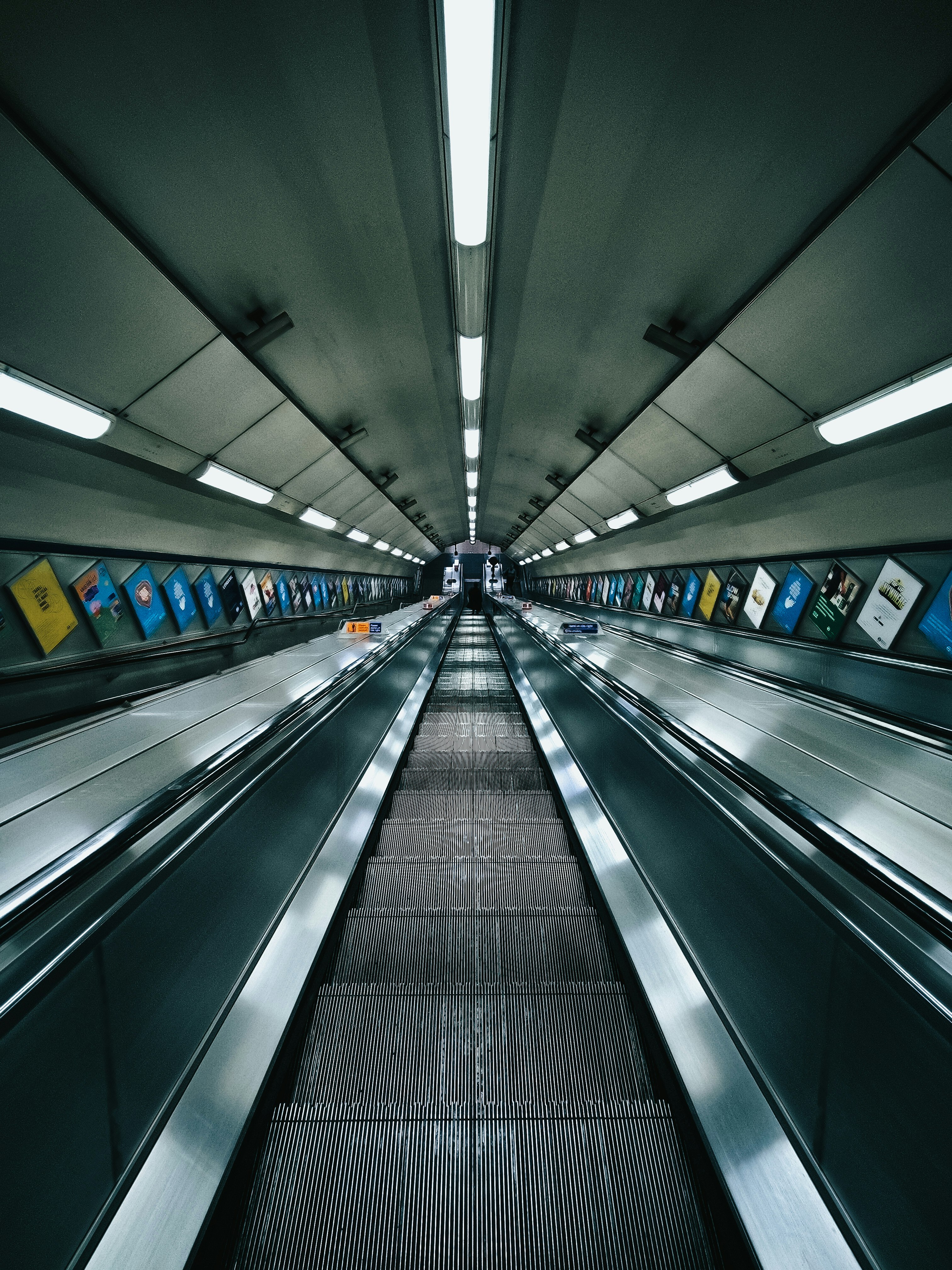 black escalator in a tunnel