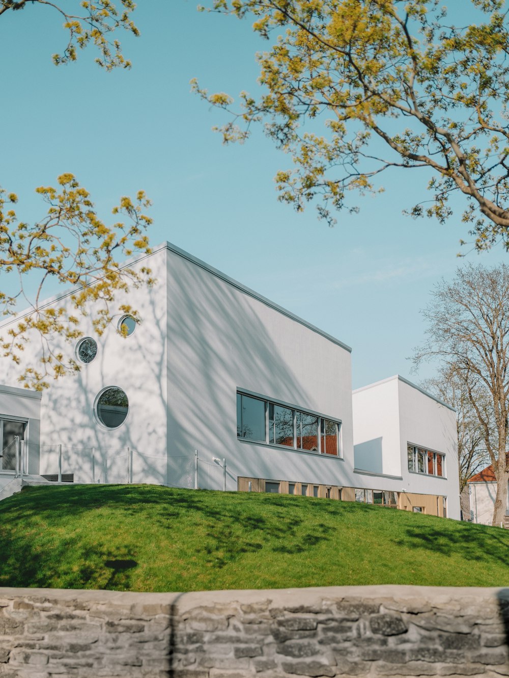 white concrete building near green trees during daytime